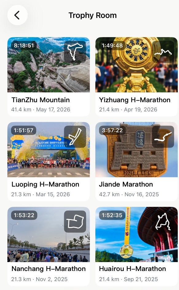 Apex Run Trophy Room: a two-column grid of race cards, each with a finisher or medal photo, a finishing time badge, a small white route shape, and the race name with its distance and date